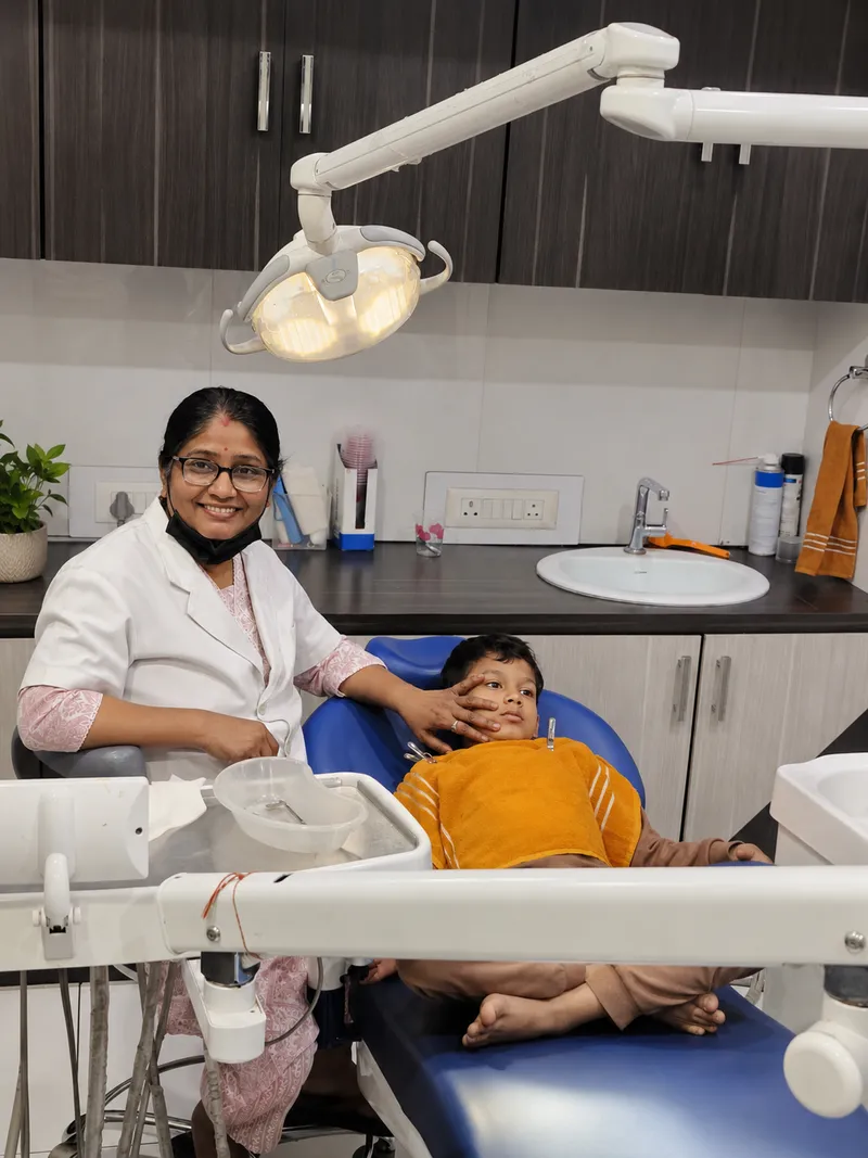 Dentist comforting a young patient in the dental chair at Sanjeevani Dental Clinic, Dimapur